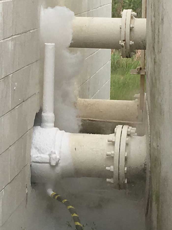 Houston, TX 10" Pipe Freeze Plug in a Tight Location Half Outside and Inside